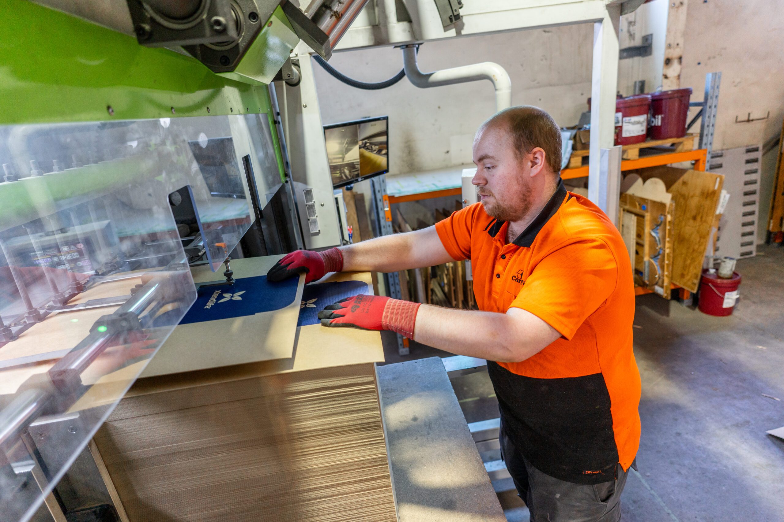 Cartons being fed into machinery by operator