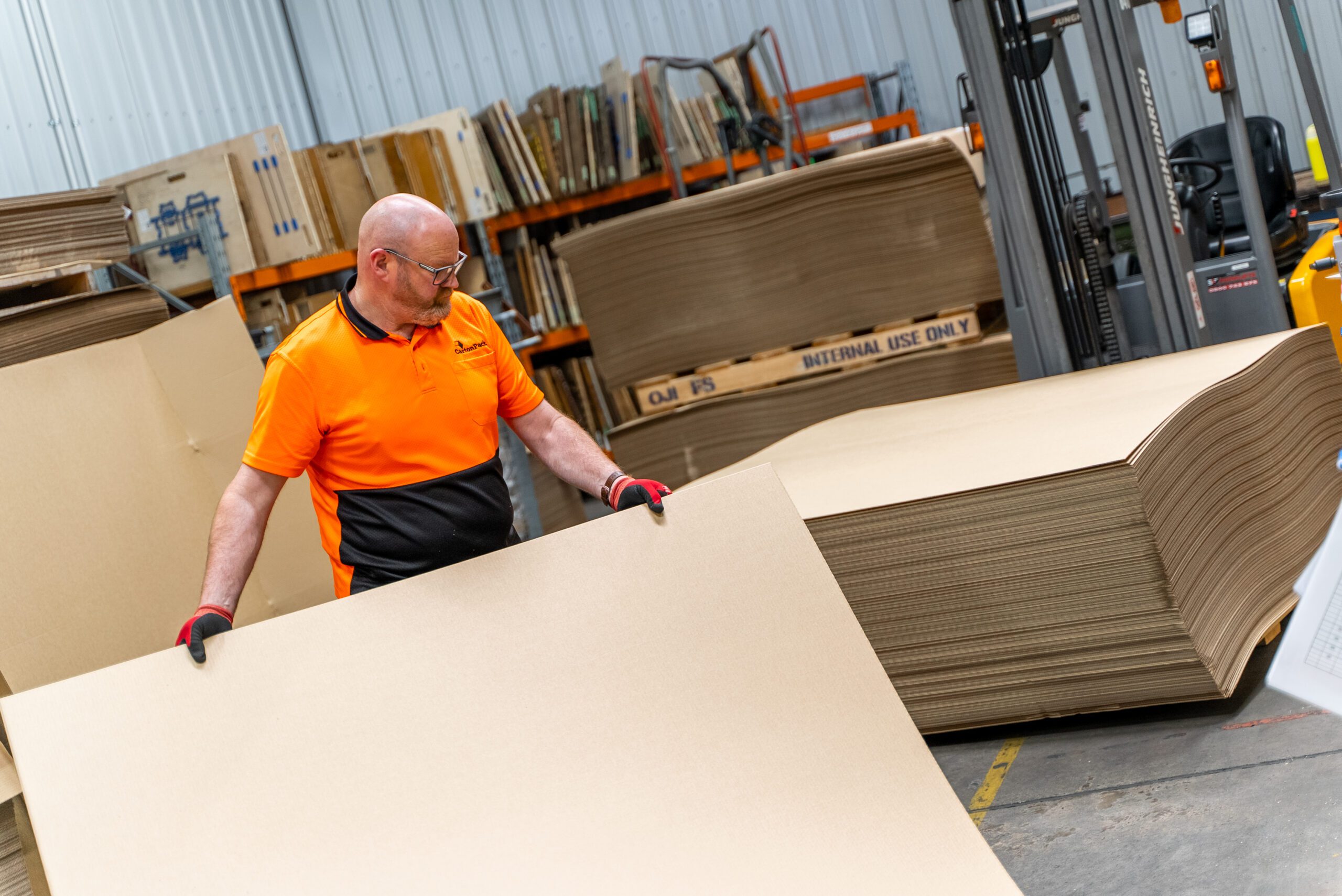 Staff feeding board into machinery